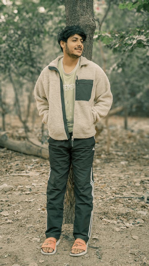 Young Man in Flip-flops Standing in the Forest