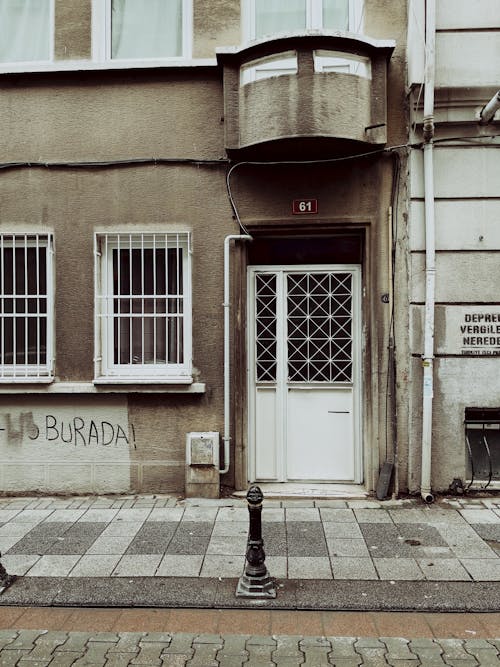 Sidewalk in Front of the Entrance with Barred Door and Windows