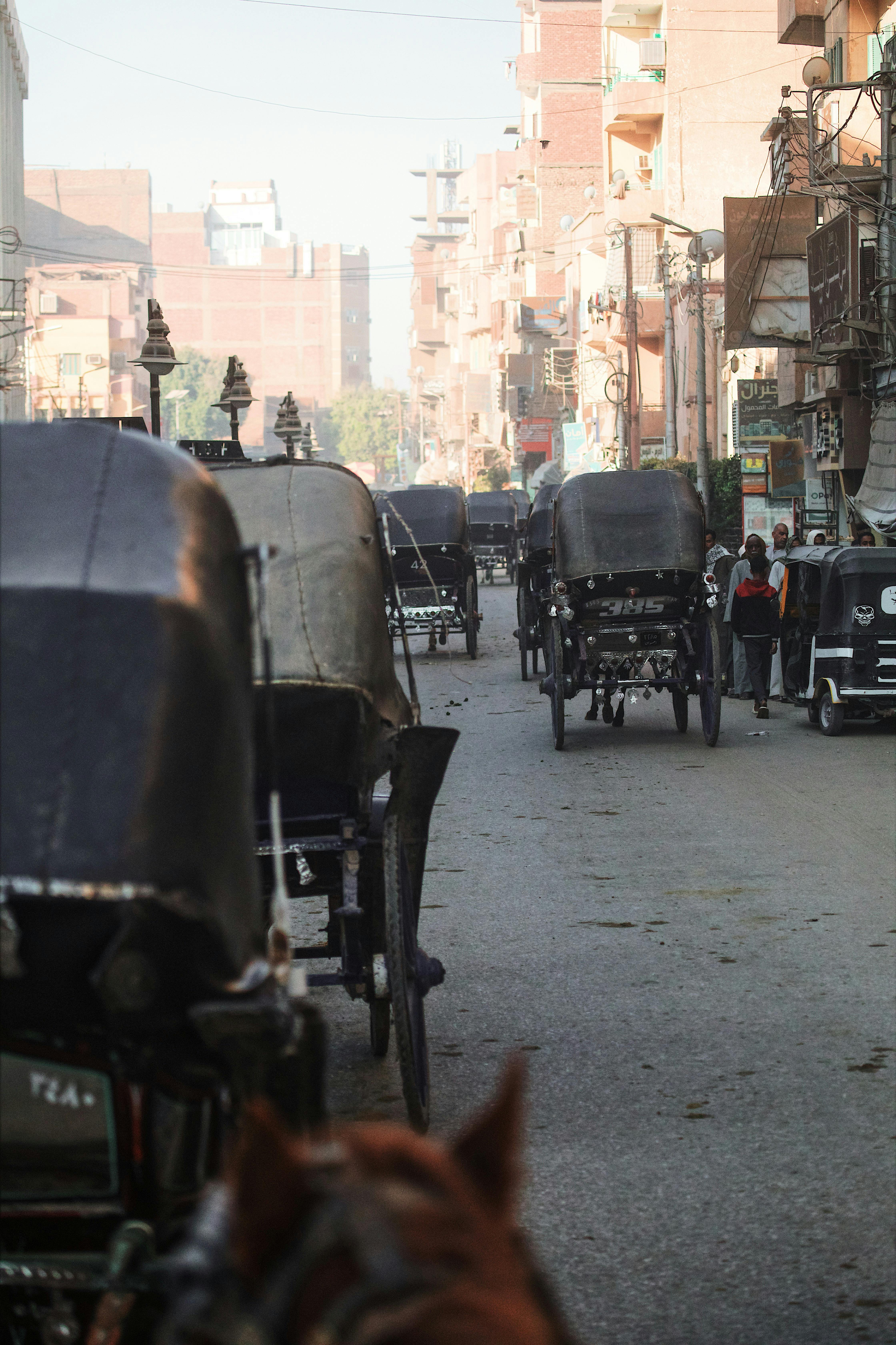 a street lined with horse drawn carriages