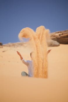 A person enjoys the desert sands under a clear blue sky, showcasing the beauty of Egypt's landscape.