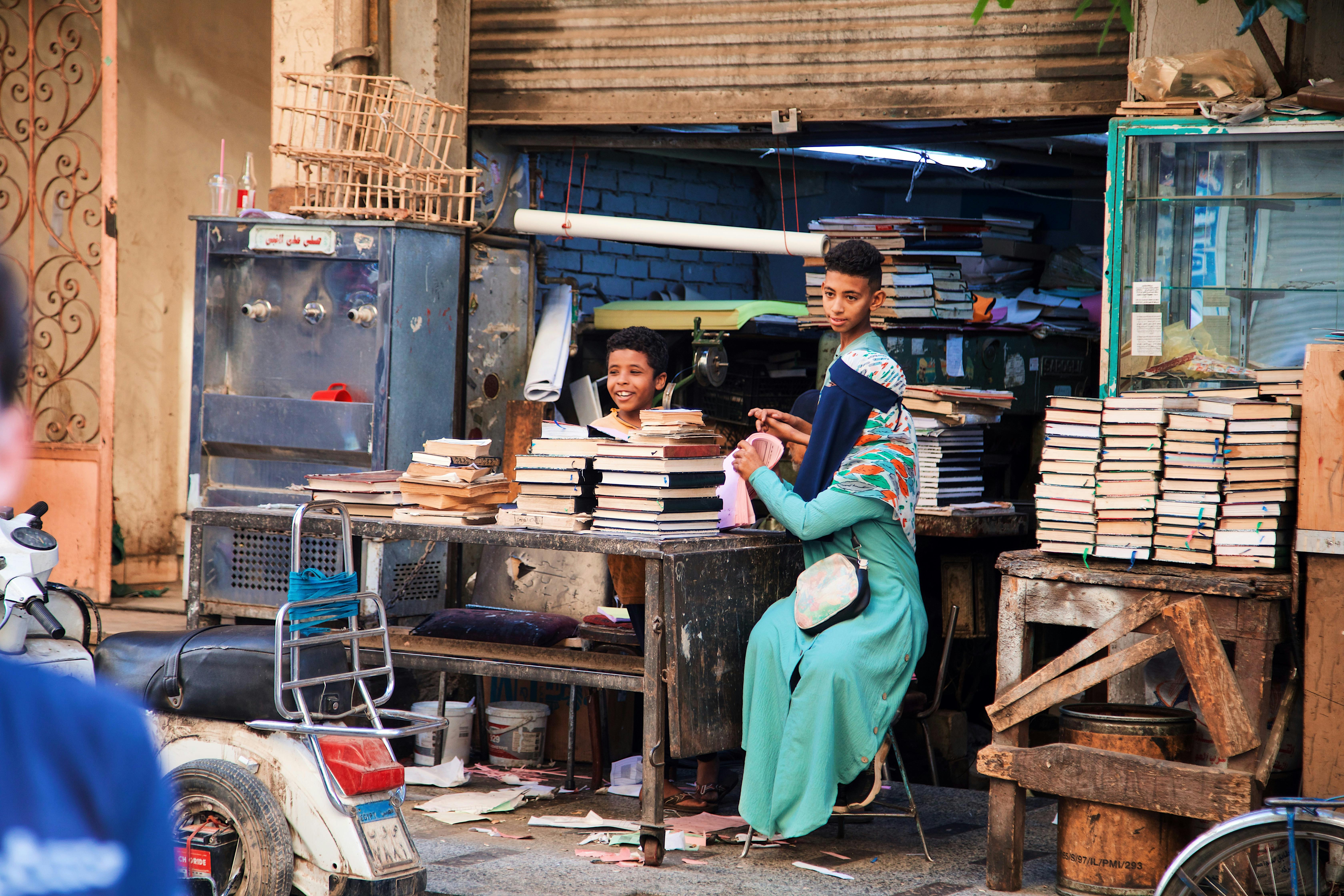 a man and woman sitting at a table in a shop