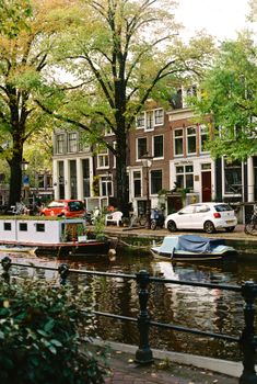 A picturesque view of Amsterdam's iconic canals with boats and classic architecture.