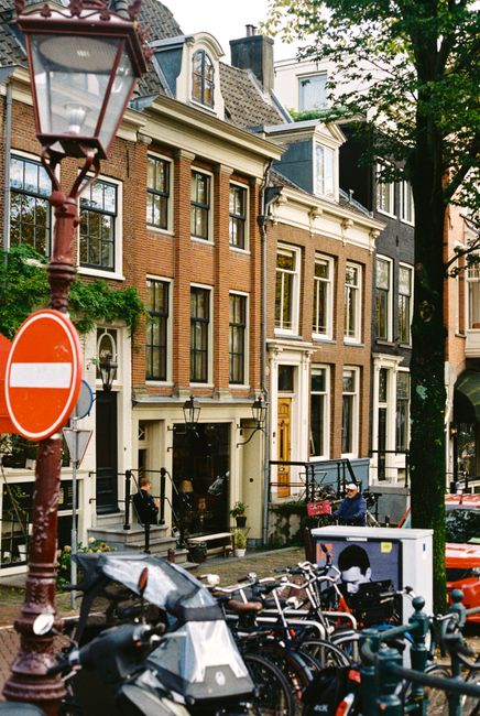 Picturesque Amsterdam street scene with traditional buildings and bicycles.
