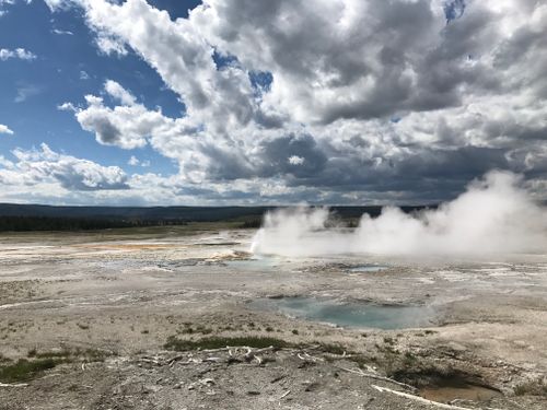 Free Majestic clouds and steaming geysers in Yellowstone National Park, Wyoming. Stock Photo