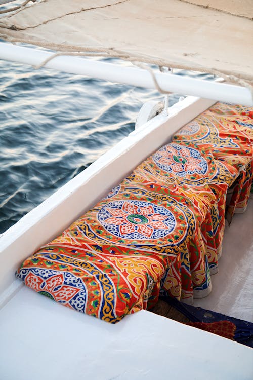 A boat with colorful cushions on the side