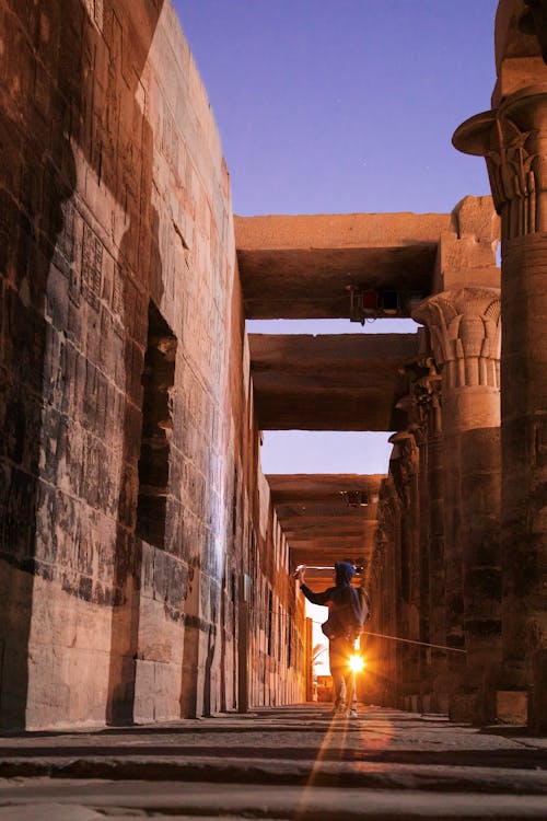 The sun sets over the temple of karnak in egypt