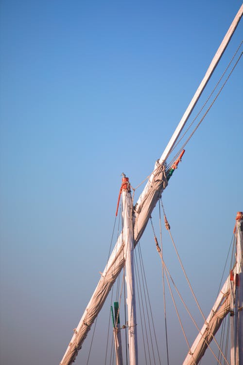 A man standing on top of a tall mast