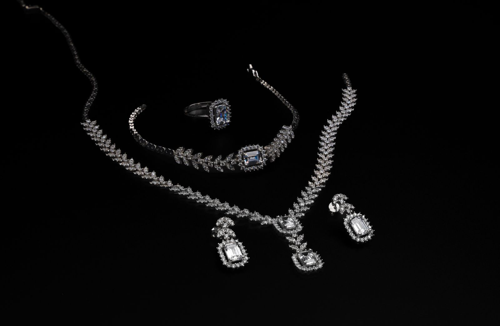 Diamond jewelry set on black backdrop
