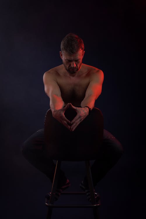 Free stock photo of dark background, man sitting, shirtless