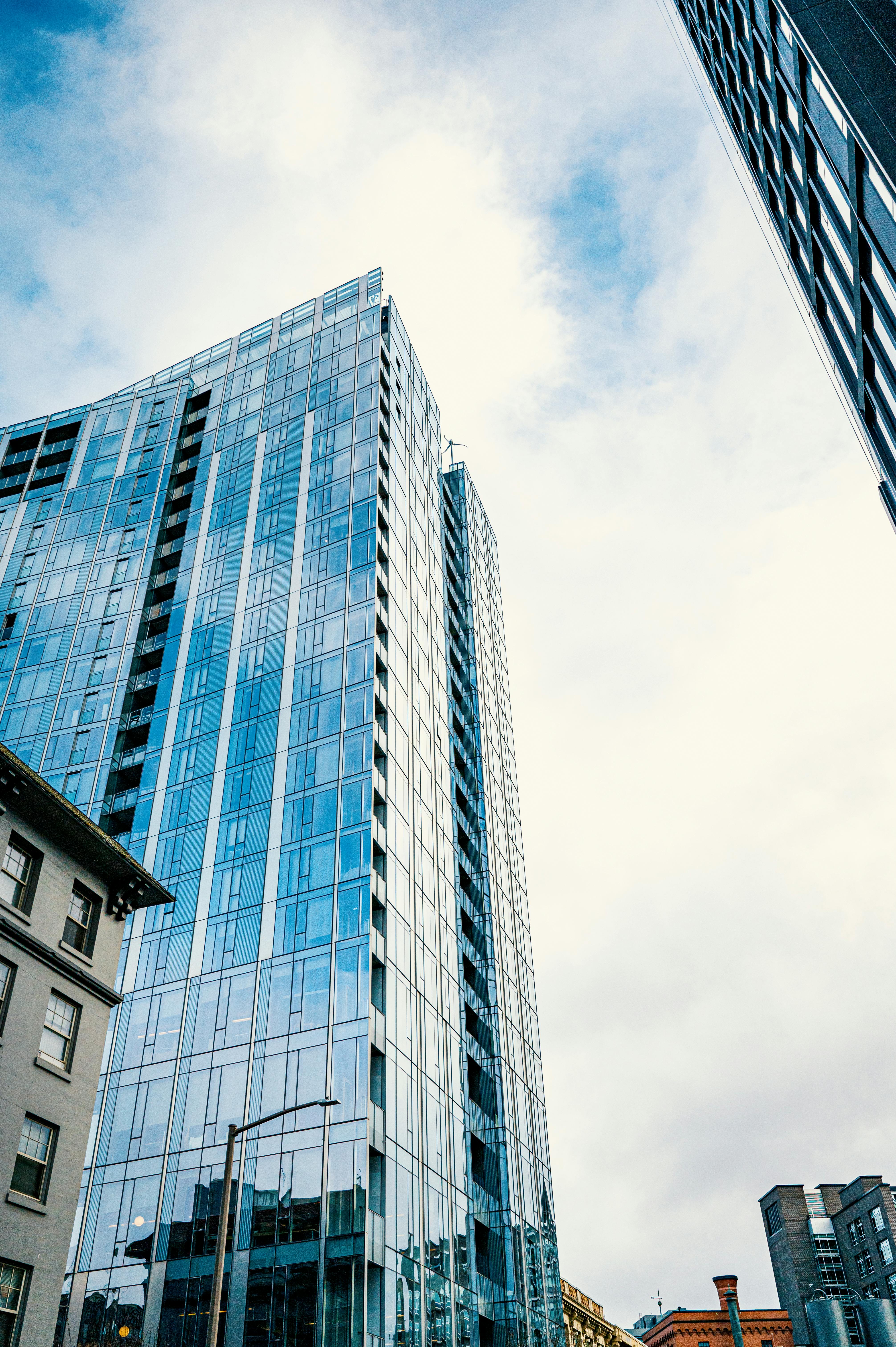 Tall modern skyscrapers with glass facades in an urban setting on a clear day.