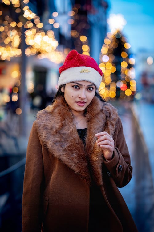 Woman in Santa Hat and Brown Coat