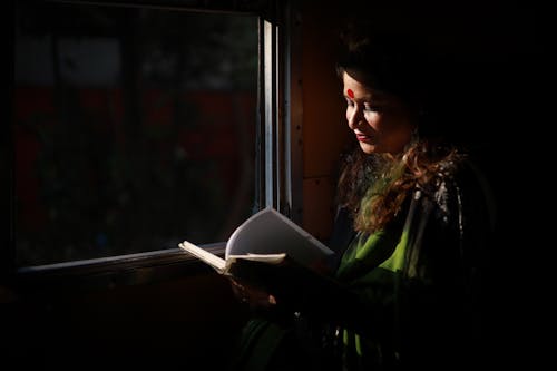 Woman with Red Bindi Reading Book