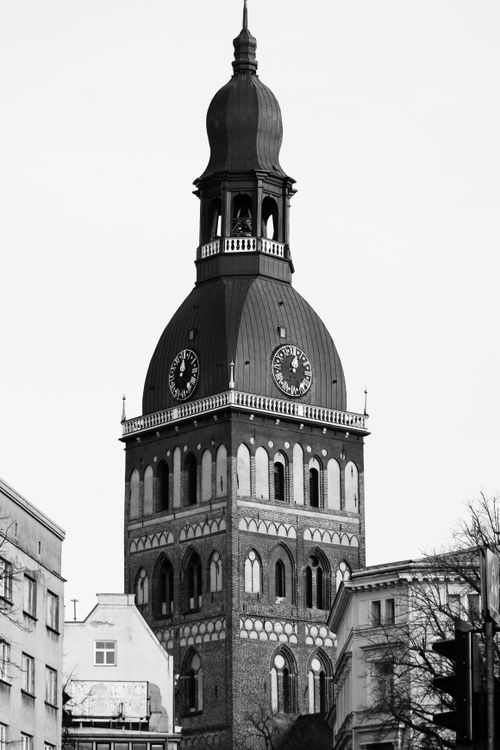 Free Black and white photo of the iconic Gothic Riga Cathedral tower, showcasing its architectural beauty. Stock Photo