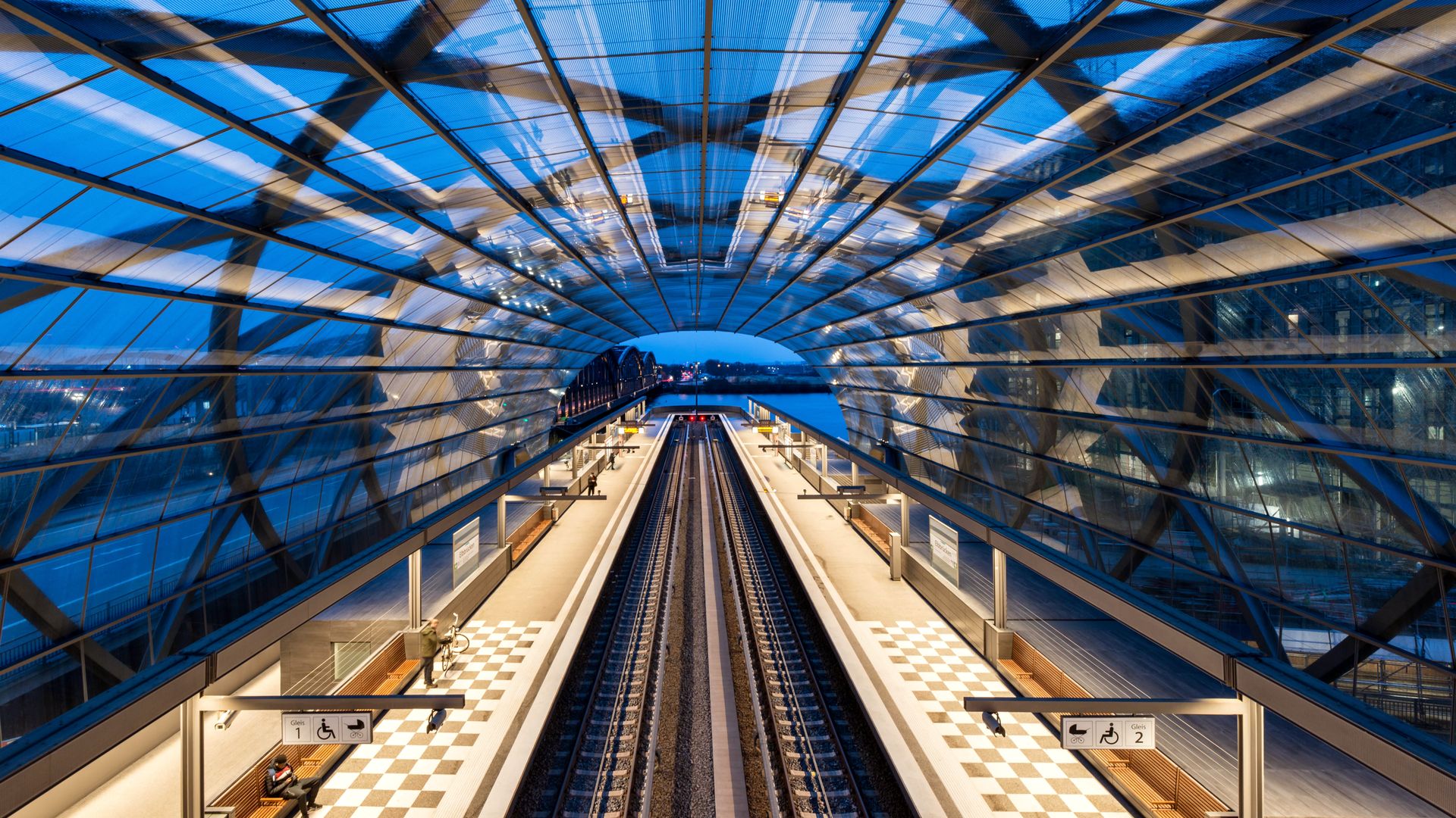 Illuminated modern railway station in Hamburg, showcasing architectural beauty and night ambience.