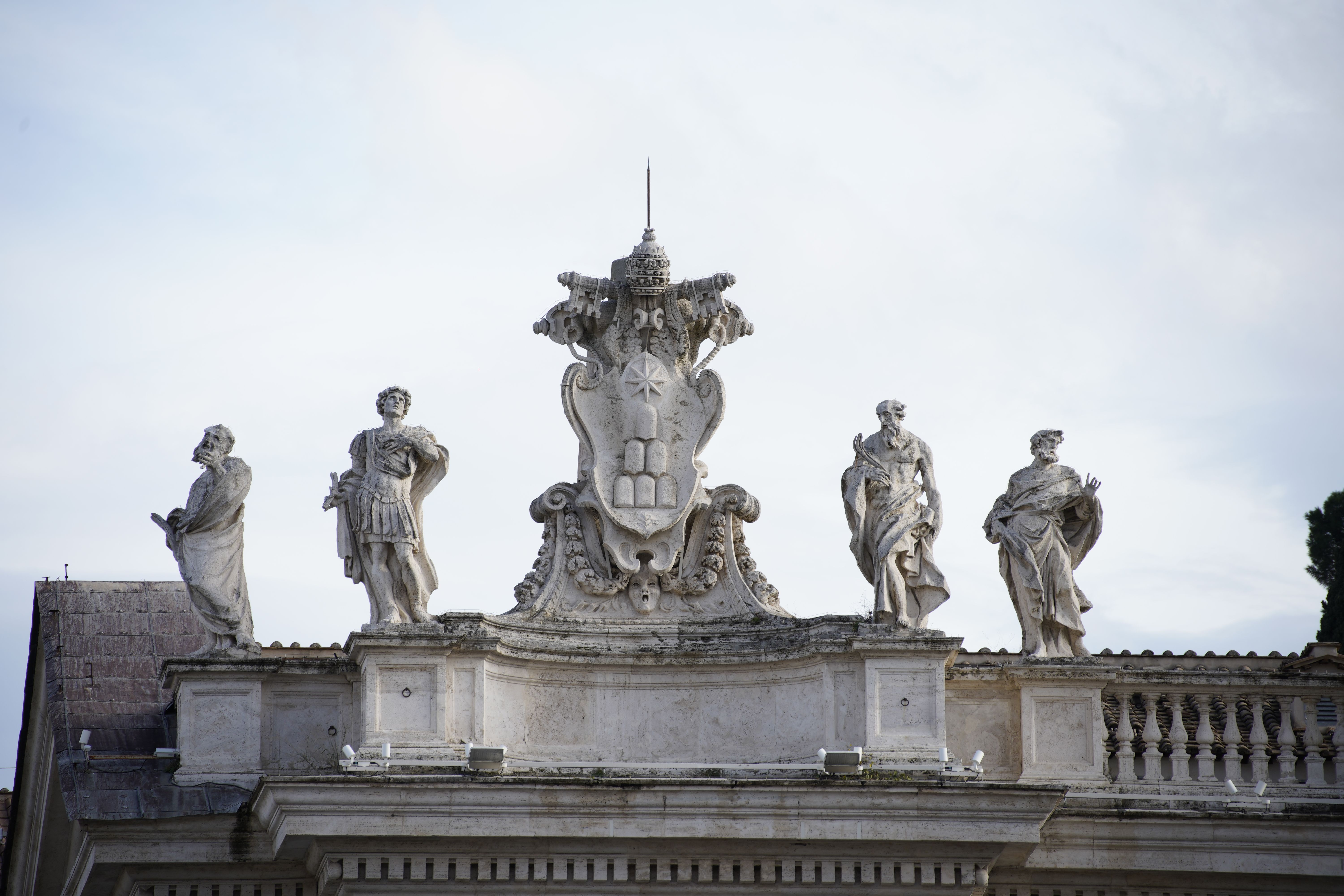 Sculptures atop St. Peter's Basilica illustrating religious artistic elegance in Vatican City.