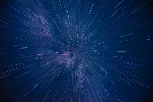 Dynamic star trails creating a dazzling starburst effect in the night sky, captured with long exposure.