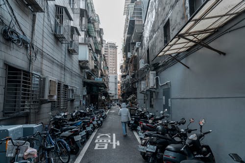 Narrow Urban Street Lined with Parked Bikes