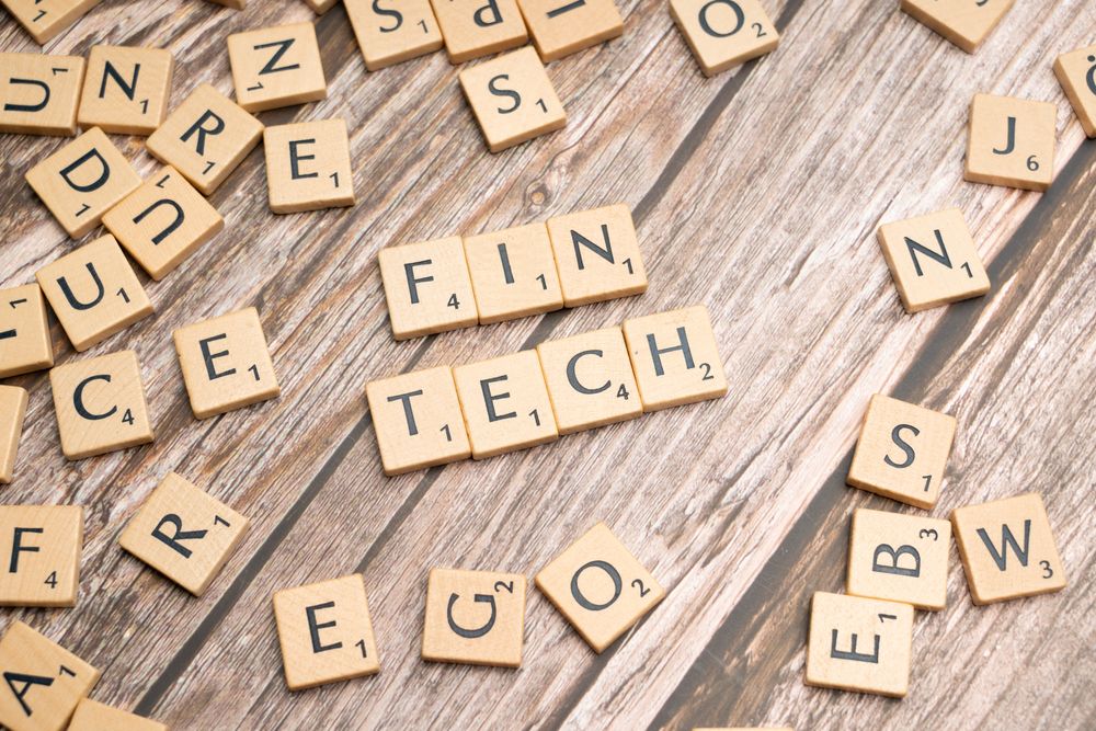 Wooden tiles spelling FinTech representing venture capital investment in financial technology startups