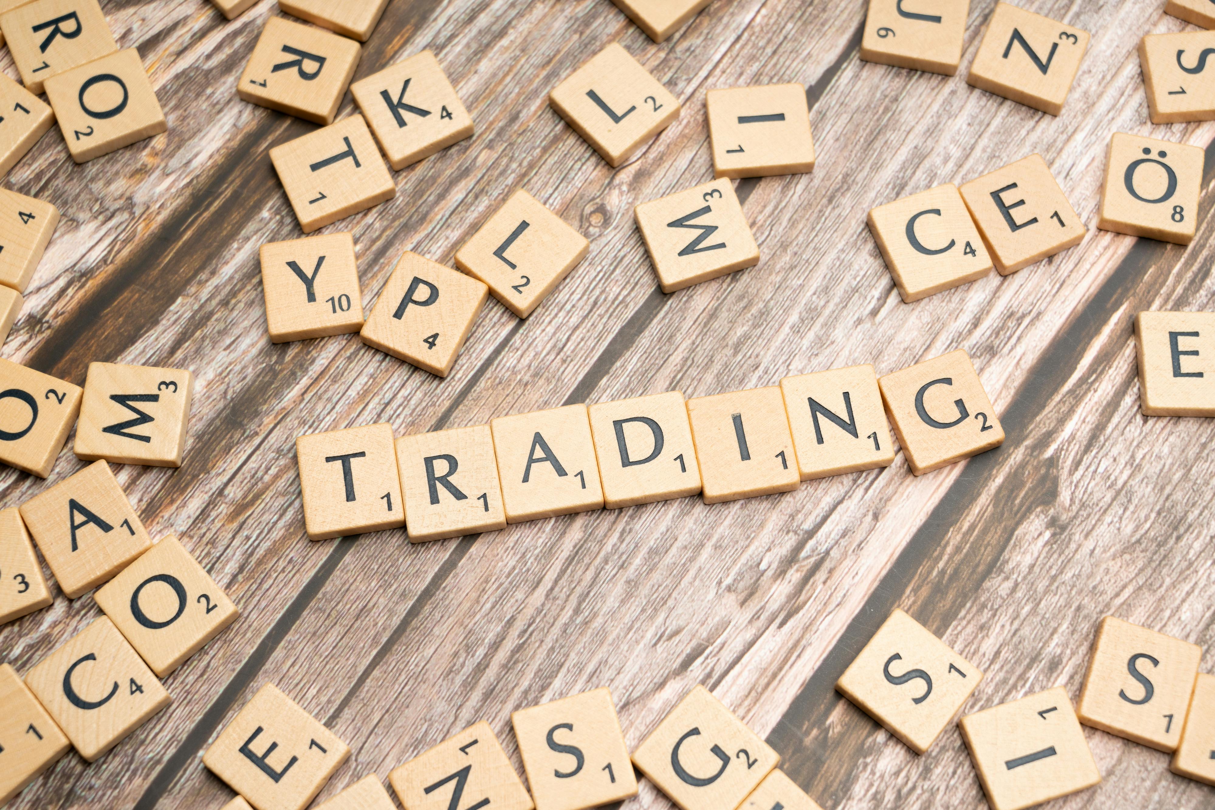 the word trading spelled out in scrabble letters