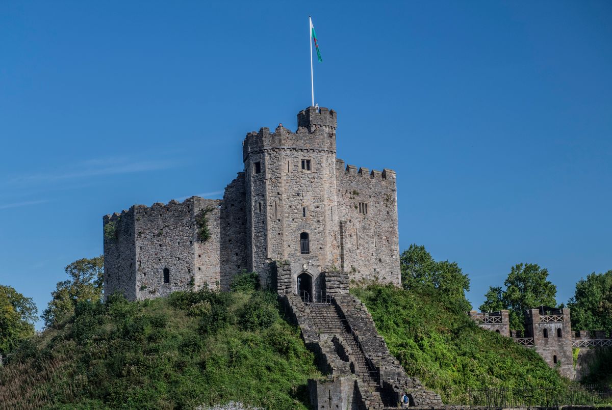 Cardiff Castle's Norman keep on its grassy motte under a clear blue sky
