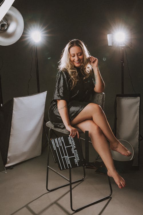 Studio Shot of a Woman Holding a Clapperboard 