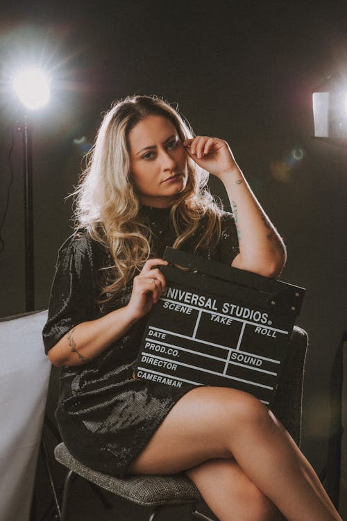 Studio Shot of a Woman Holding a Clapperboard