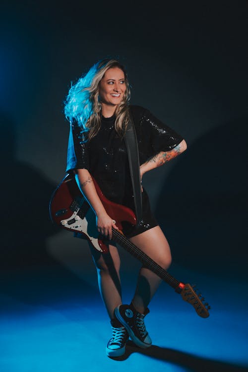Studio Shot of a Woman with an Electric Guitar 