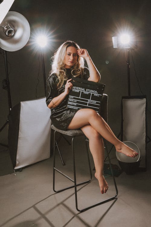 Studio Shot of a Woman Holding a Clapperboard