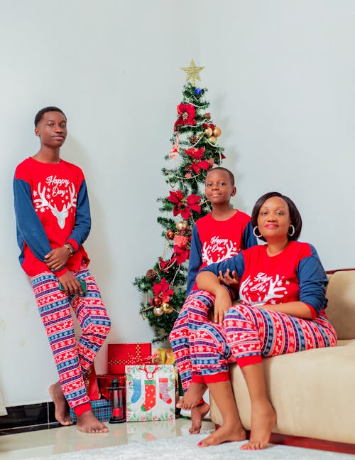 Mother with Sons Sitting next to a Christmas Tree 