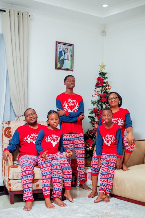 Free Happy Family in Christmas Pyjamas Posing Together in Living Room Stock Photo