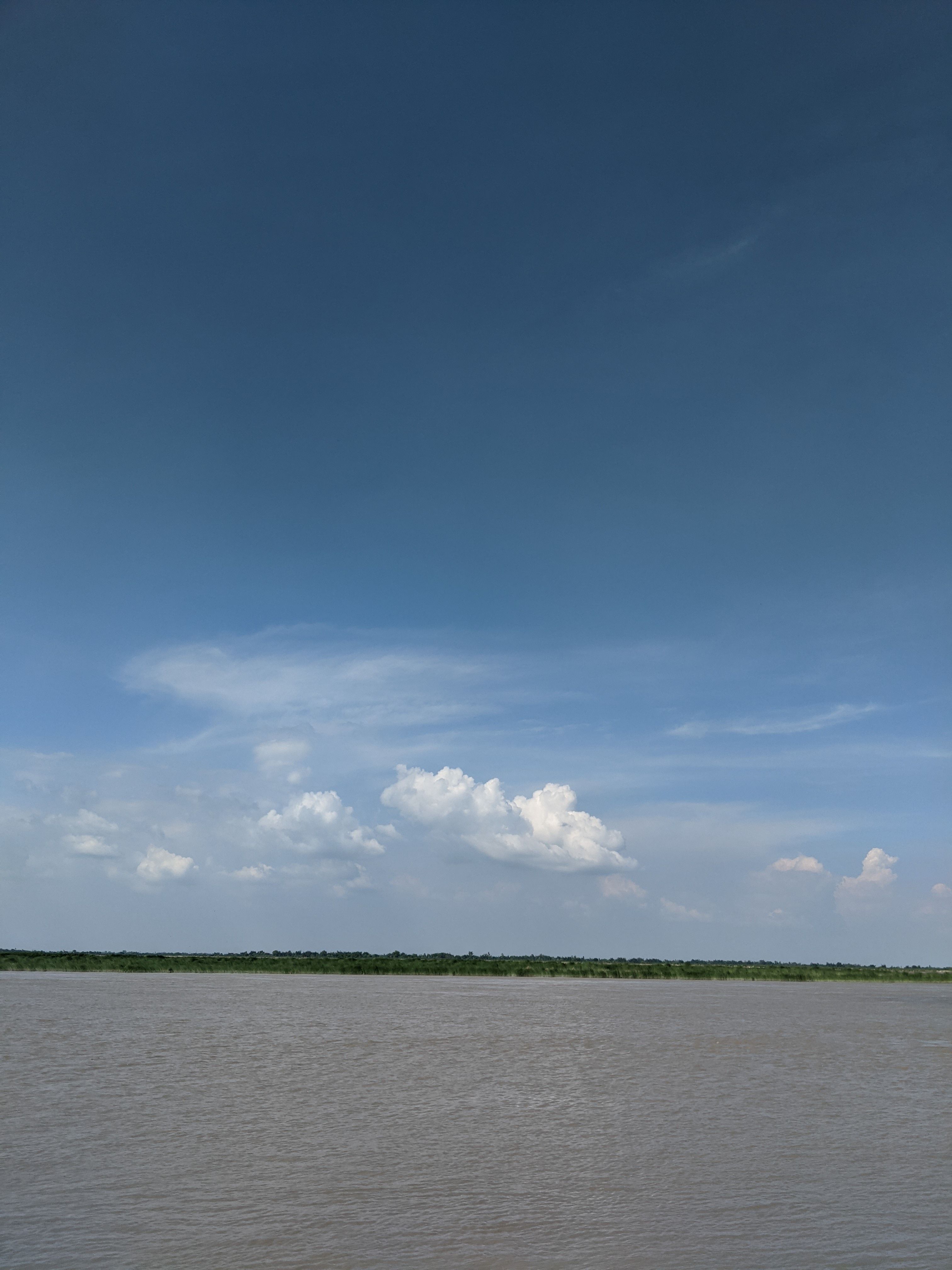Wide River under Blue Sky · Free Stock Photo