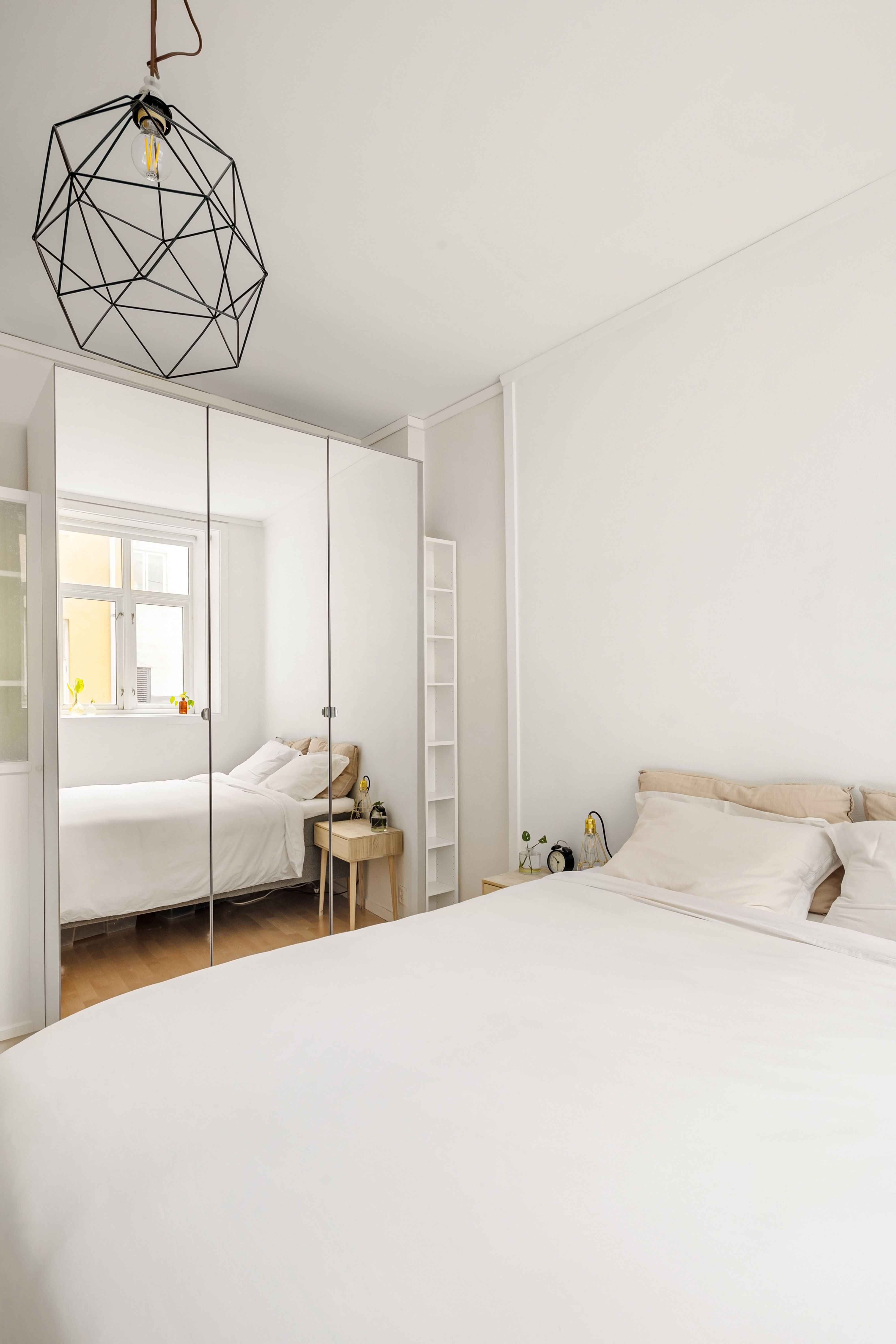 Minimalist bedroom with mirrored wardrobe