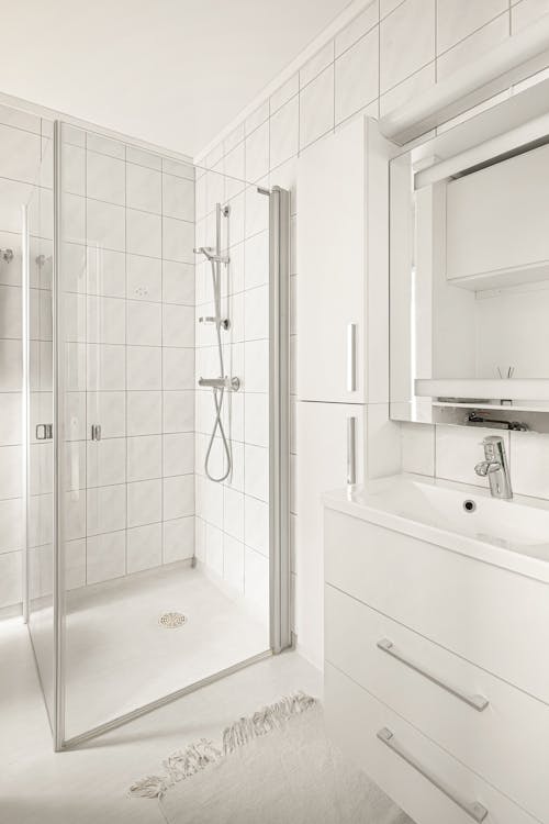 Interior of a Modern Bathroom with White Tiles and Furniture 