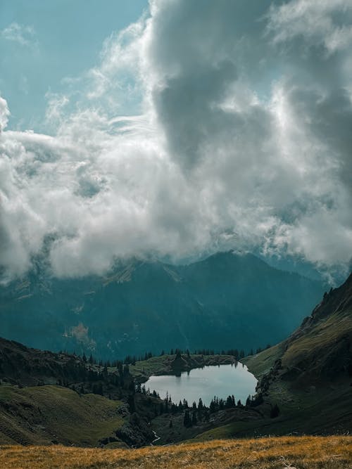 Cloud over Lake in Valley in Mountains