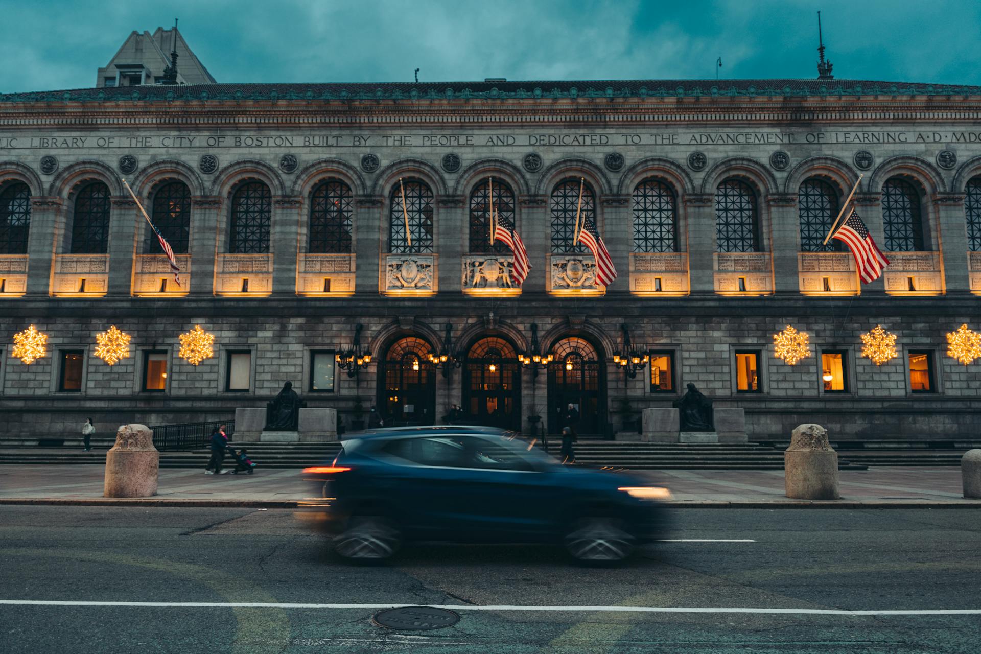 Car Passing the Boston Public Library at Dusk