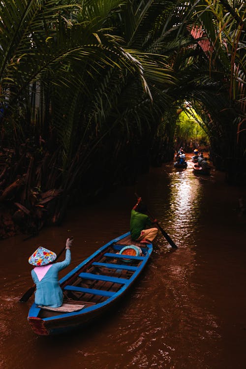 Woman on a Wooden Boat in a River in a Jungle 