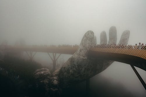 People on the Golden Bridge in Vietnam during a Foggy Weather