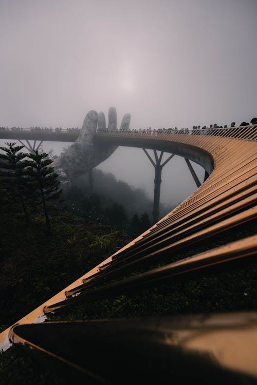 People on the Golden Bridge in Vietnam during a Foggy Weather