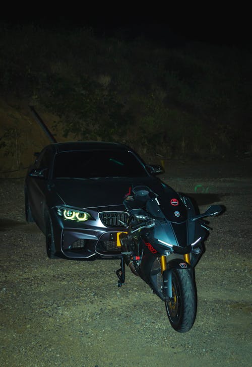 Sports BMW Car and Yamaha Motorbike at Night