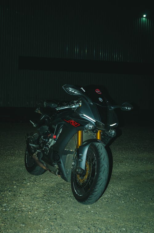 Black Motorcycle Standing Outdoors at Night