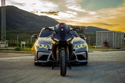A Car and a Motorcycle at Sunset 