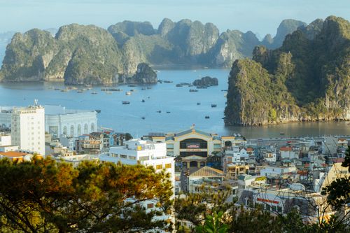 Free A stunning aerial view of Ha Long Bay, showcasing limestone karsts and urban landscape. Stock Photo
