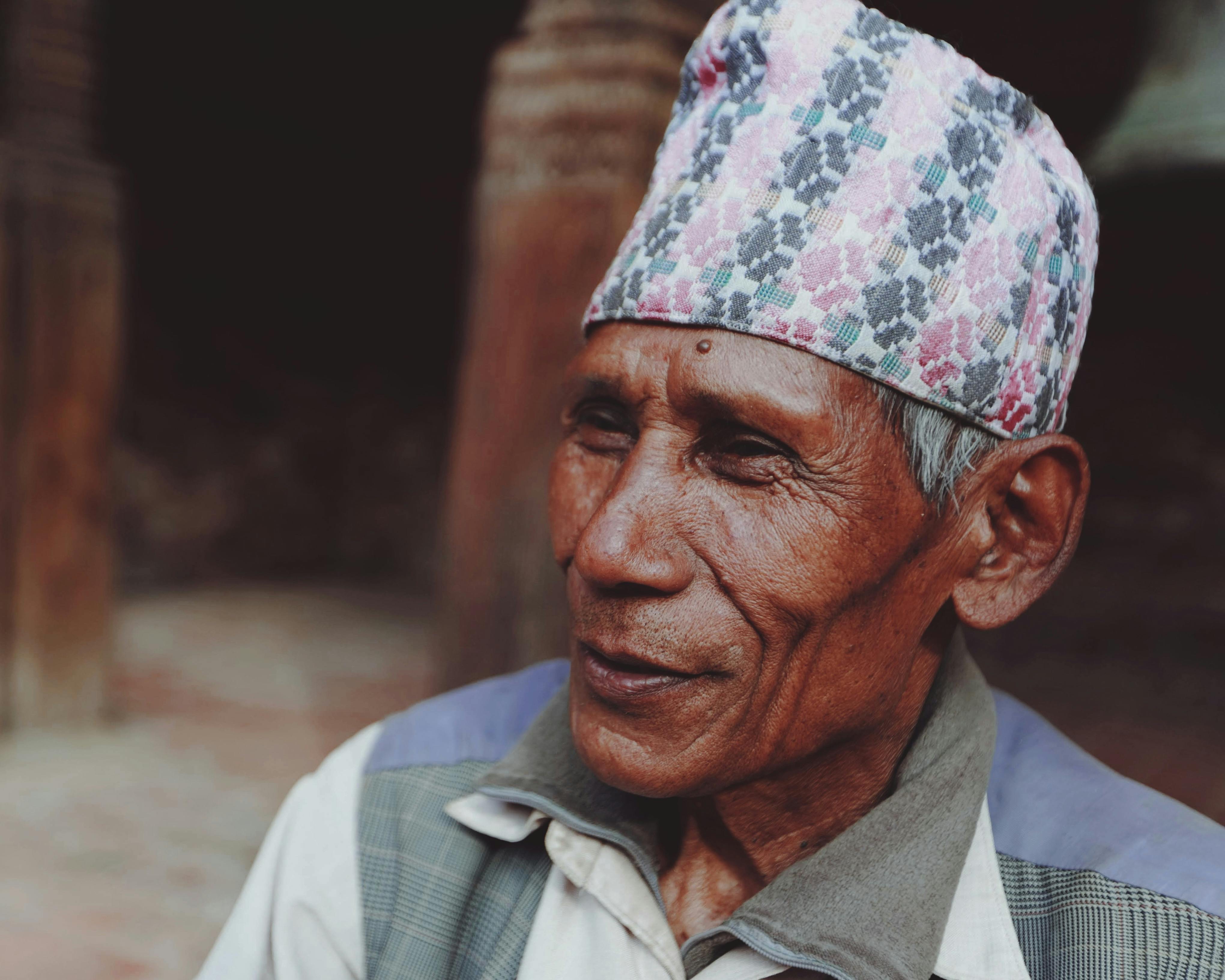 Elderly man wearing traditional cap, exuding wisdom and cultural heritage.
