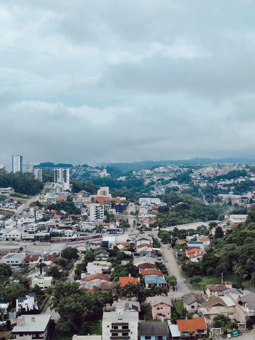 Free A panoramic view of an urban area with residential buildings and a cloudy sky. Stock Photo
