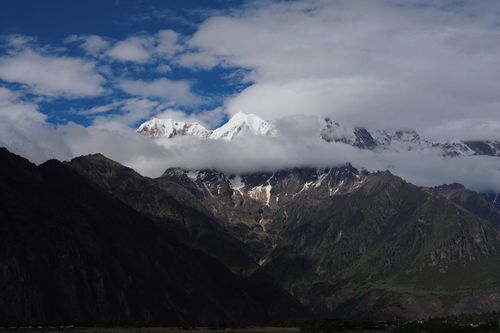 Free Breathtaking view of snowcapped peaks with dramatic clouds and deep valleys. Stock Photo