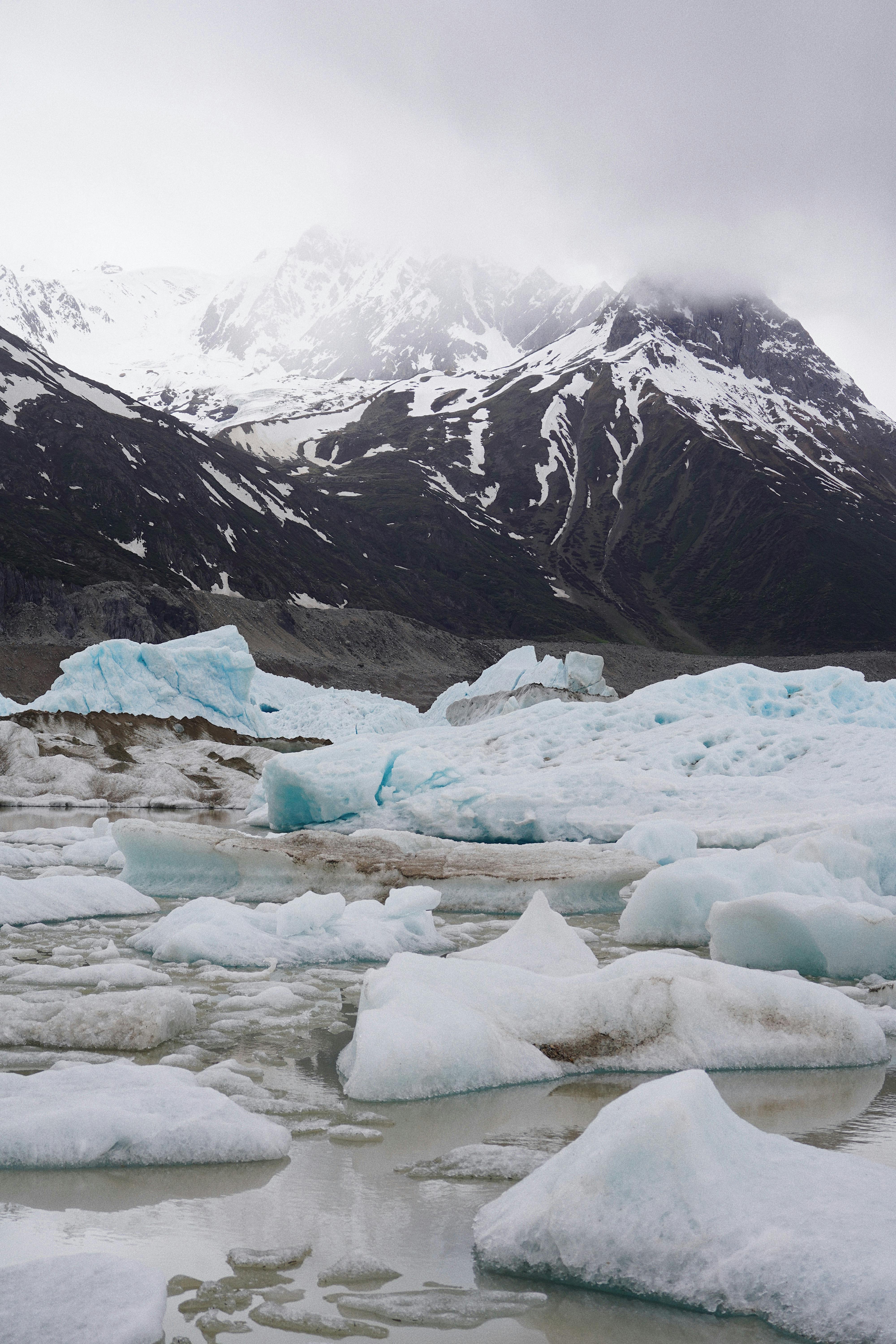 Breathtaking winter scene of snow-covered mountains and icy glaciers. Cold and serene.