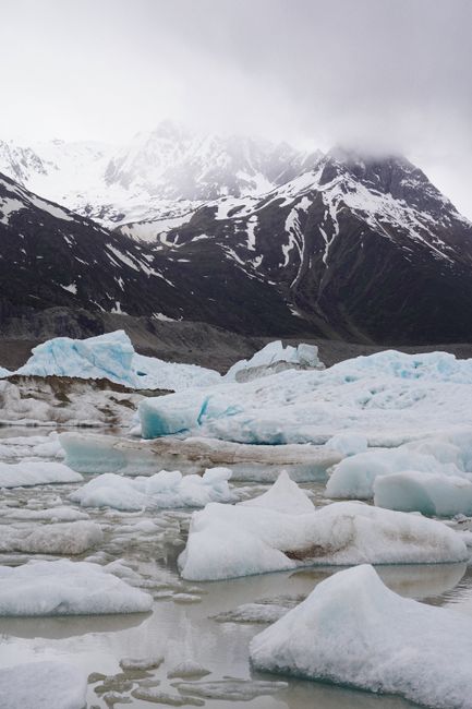 Breathtaking winter scene of snow-covered mountains and icy glaciers. Cold and serene.