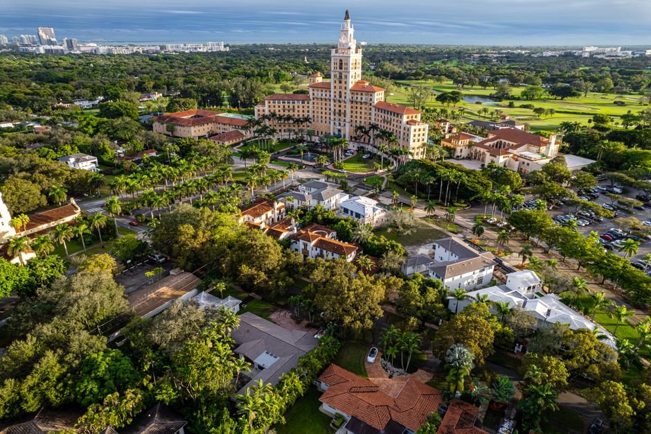 Incredible Miami Private Helicopter Flight with Champagne Review: The Ultimate VIP Experience Over Magic City Review 2026 - Stunning aerial shot of a luxury hotel in Miami surrounded by lush greenery and urban landscape.
