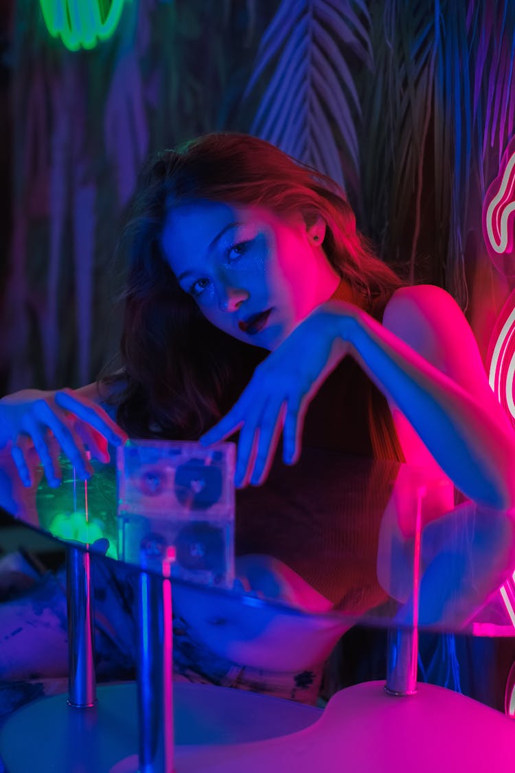 Woman Sitting In Blue Light At Club