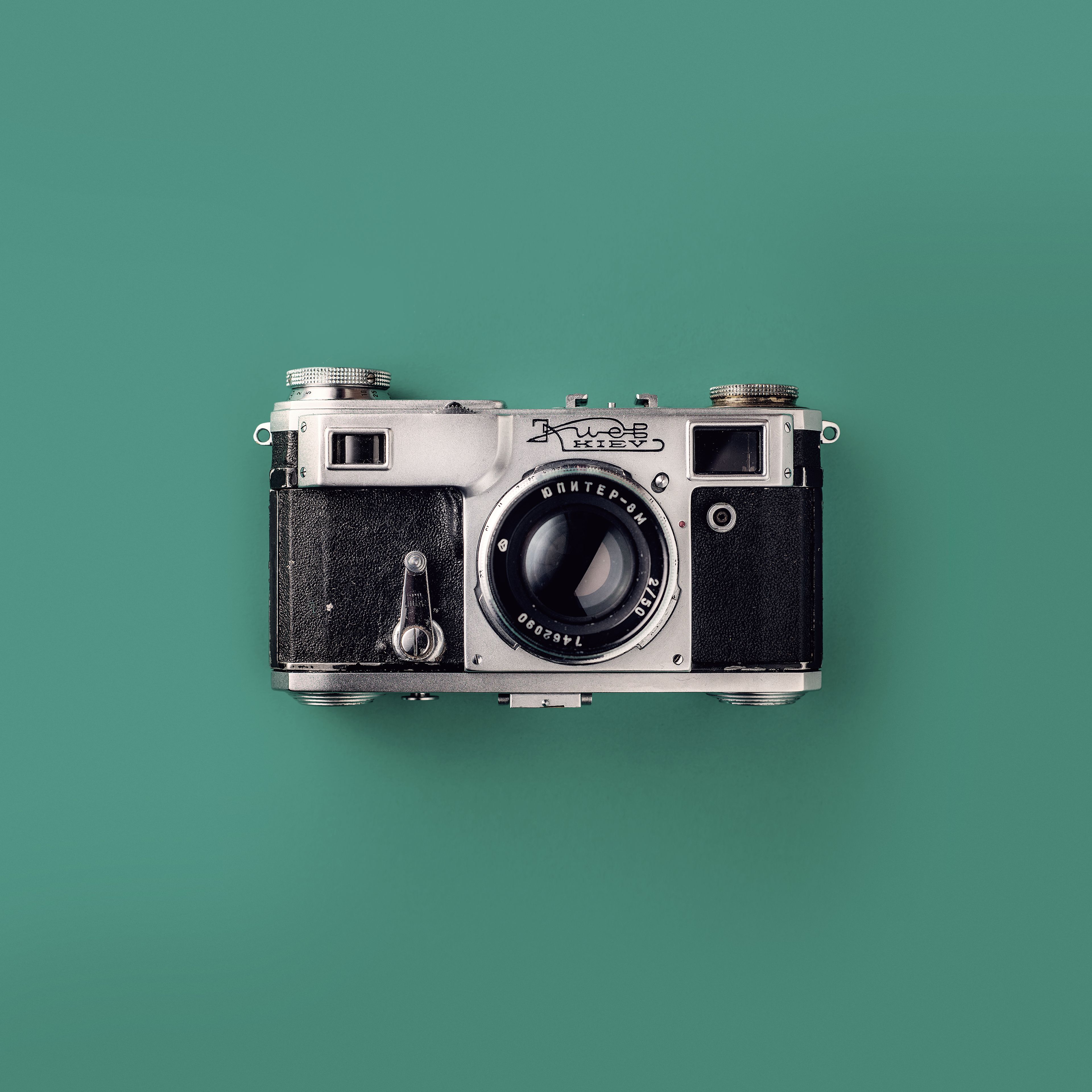 Grey and Black Camera On Green Background